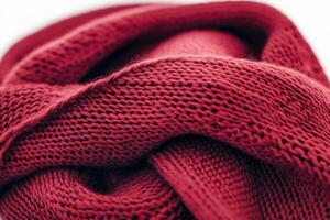 Dark cherry scarf showcases intricate knit patterns, adding warmth and vintage flair to any outfit photo