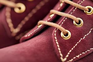 Close-up of dark cherry suede boots with gold accents, capturing a retro glamour style and chic nostalgia photo