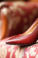 Cherry-colored high-heeled shoes rest elegantly against retro furniture, showcasing a romantic look photo