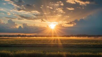 Sunrise breaking through clouds over a field highlighting climate change impact photo