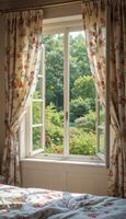 A cozy bedroom window adorned with floral curtains, providing a view of lush garden greenery just outside, creating a peaceful and inviting atmosphere. photo