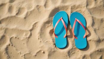 Bright blue flip-flops resting on golden sand, suggesting a beach setting. Great for summer vibes, travel promotions, or beach-related products. photo