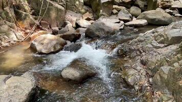 Water stream flow from up to down along rocky way in waterfall. video