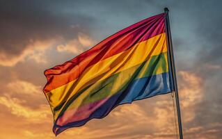 LGBT Pride rainbow flag over blue sky background with empty space for text. Diversity, love, freedom and LGBT concept. Horizontal view. photo