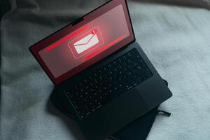 Spam email concept on laptop screen. Internet security. Spam, junk and e-marketing. Email Pop up Warning. photo