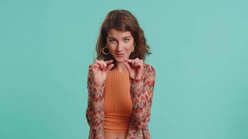 Woman showing a little bit gesture with sceptic smile showing minimum sign measuring small size video