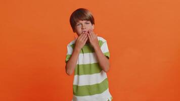 Frightened child boy closing mouth with hands refusing to tell terrible secret, unbelievable truth video