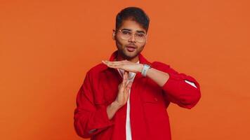 Tired upset Indian man showing pause gesture, limit or stop sign, time out, take a break relax, rest video