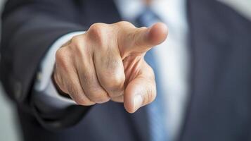 Close Up of a Man's Hand Pointing Directly at the Camera in a Dark Suit photo