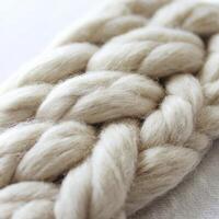 Close Up of Chunky Knit Fabric, Off White Braided Texture, Soft Natural Fibers photo