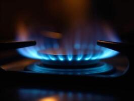 Soft blue flames on a gas burner in darkness photo