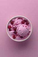 An overhead view of a bowl of ice cream with raspberries photo