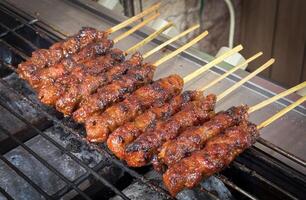 skewered beef meat on a grill, or barbecue bbq, locals called it beef satay showcasing their vibrant glaze and texture photo