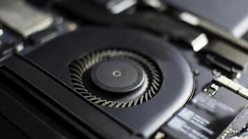 a close up of a notebook motherboard with a fan photo