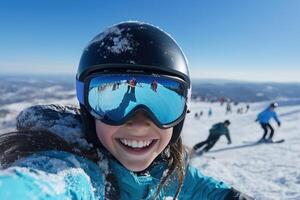Portrait of a girl in a ski helmet and goggles on the background of the mountains photo