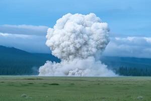 large cloud of smoke from an explosion at the edge of a forest photo