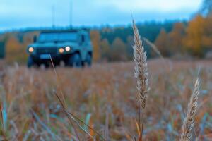 Autumn landscape with the military vehicle on the background of the field photo