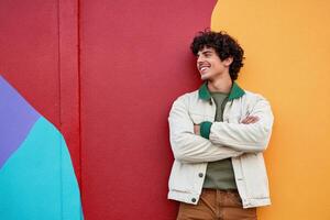 Young man enjoys vibrant colors while posing confidently against an background photo