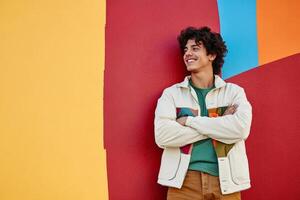Young man enjoys vibrant colors while posing confidently against an abstract background photo