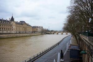 Seine River View with Paris Landmarks and Bridge on a Cloudy Day photo