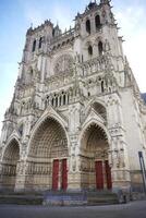 Front view of Gothic cathedral with red doors. Amiens. France 17.02.2025 photo