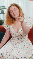 Pretty young woman smiling, pointing to camera, choosing lucky winner, indicating, inviting, approve video