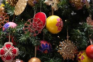 Christmas tree adorned with colorful handcrafted ornaments and sparkling lights photo