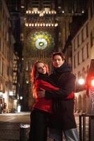 Couple embracing in front of Strasbourg Cathedral at night photo