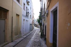 Cobblestone street with colorful buildings in the old town of Badajoz, Spain photo
