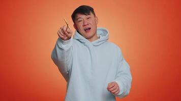 Magician wizard handsome man gesturing with magic wand making wish come true, casting magician spell video
