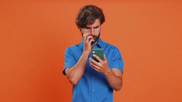 Man use smartphone typing browsing loses becoming surprised sudden lottery result bad fortune video