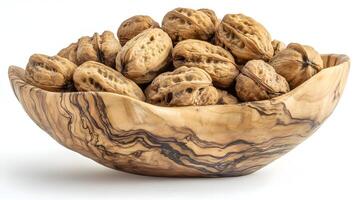 A rustic wooden bowl overflowing with a bounty of walnuts, a simple yet elegant presentation of nature's wholesome goodness in warm, natural light. photo