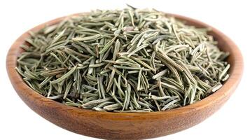 Dried rosemary herb, a fragrant culinary delight nestled in a rustic wooden bowl, ready to enhance your cooking with its earthy aroma and subtle piney notes. photo