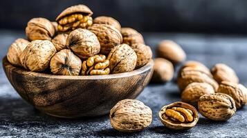 A rustic wooden bowl overflowing with wholesome walnuts, ready for snacking or baking, bathed in warm, inviting light. photo