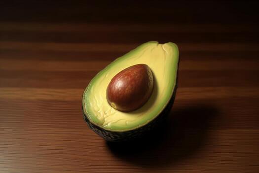 Avocado cut in half isolated on brown background. photo