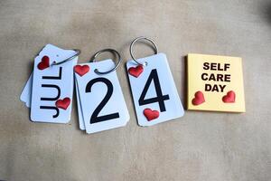Date 24th of July on the calendar. Self care day on the table background photo