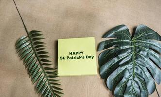 Concept of Happy St. Patrick's Day write on sticky notes isolated on Wooden Table. photo