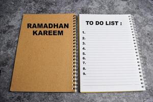 Ramadhan Kareem, To do list write on colour notebook isolated in dark background photo
