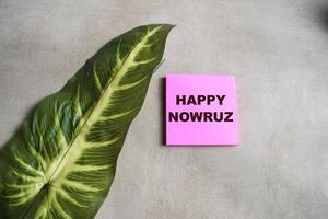 Concept of Happy Nowruz write on sticky notes isolated on Wooden Table. photo