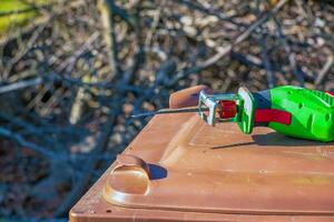 Mini electric saw for cutting small branches of trees and shrubs is ready for work. photo
