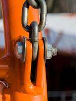 Close up of bolt fastener with washers and nuts with chain. Vertical. photo