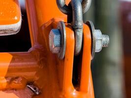 Close up of bolt fastener with washers and nuts with chain. View from an angle. photo