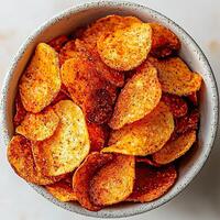a bowl of potato chips sitting on a table photo
