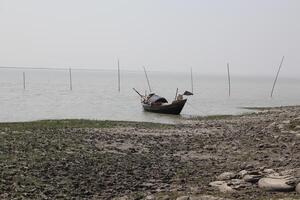 A boat tied up by the river. photo