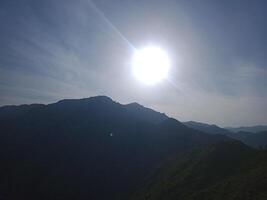 Bright Sun Over Mountain Range with Clear Sky photo