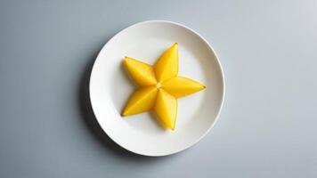 A plate with a star shaped piece of fruit on it photo