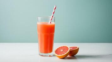 Grapefruit juice with straw and half grapefruit photo