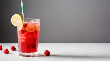 A glass of raspberry lemonade with a straw photo