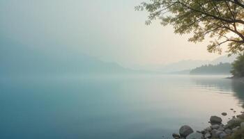 Serene Lake View with Misty Mountains and Calm Waters at Dawn photo