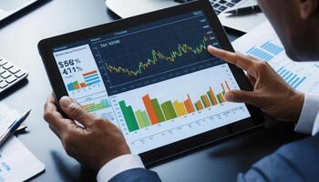 Business Professional Analyzing Financial Data on Digital Tablet photo